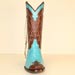 custom turquoise caiman cowboy boot with buckstitching and silver crosses